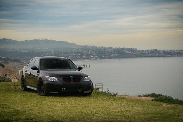 Black BMW Sedan on the lake shore