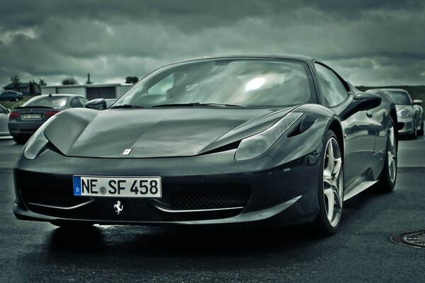 Black and white image of a Ferrari in the parking lot