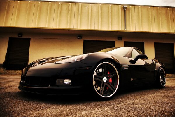 Gray corvette car in front of the house