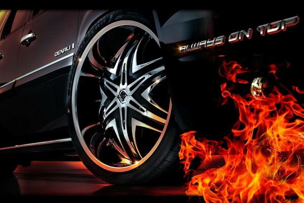 Огонь из-под колеса черного автомобиля