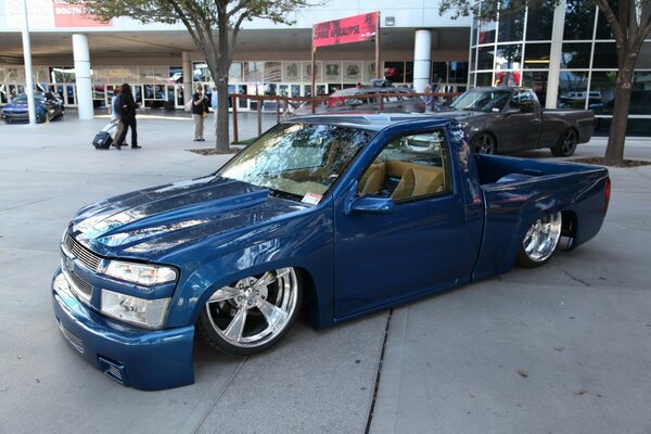 Understated blue wheelbarrow on chrome wheels