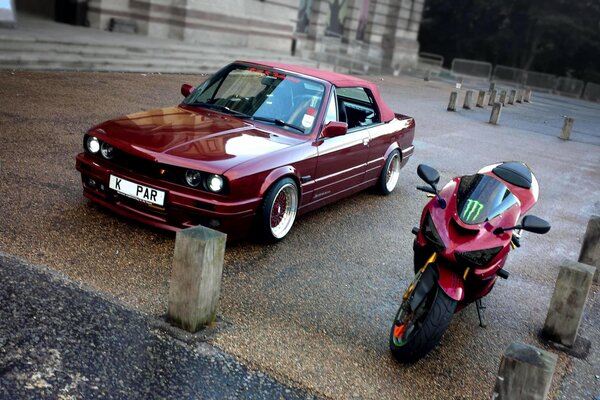 Red retro car with red motorcycle