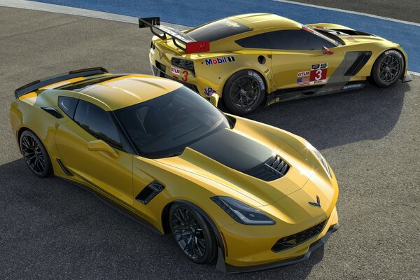 Yellow corvette cars on brown asphalt