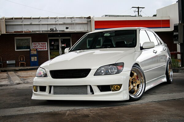 White tuned car on the background of buildings