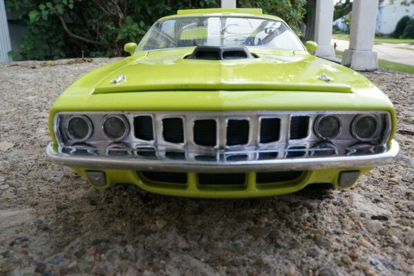 A light green car on the rocks