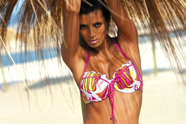 Beach, photo of a girl under a canopy in a swimsuit