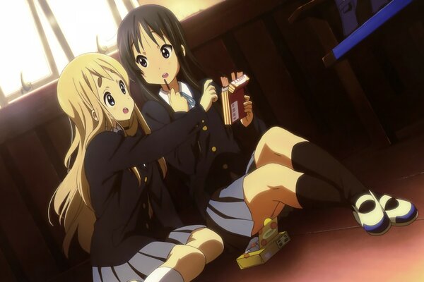 Anime. Zwei Schulmädchen sitzen auf dem Boden