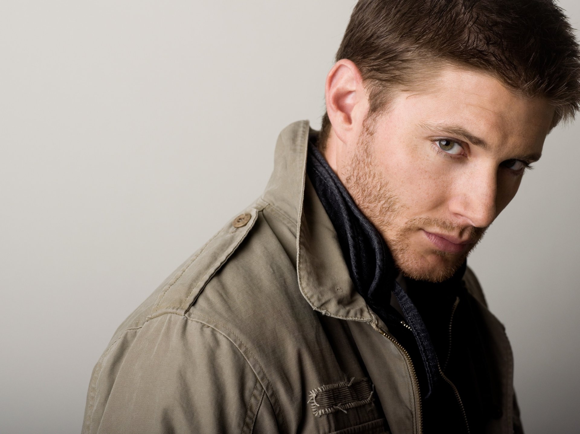 a come-hither look jensen handsome portrait look jacket unshaven background eyes face