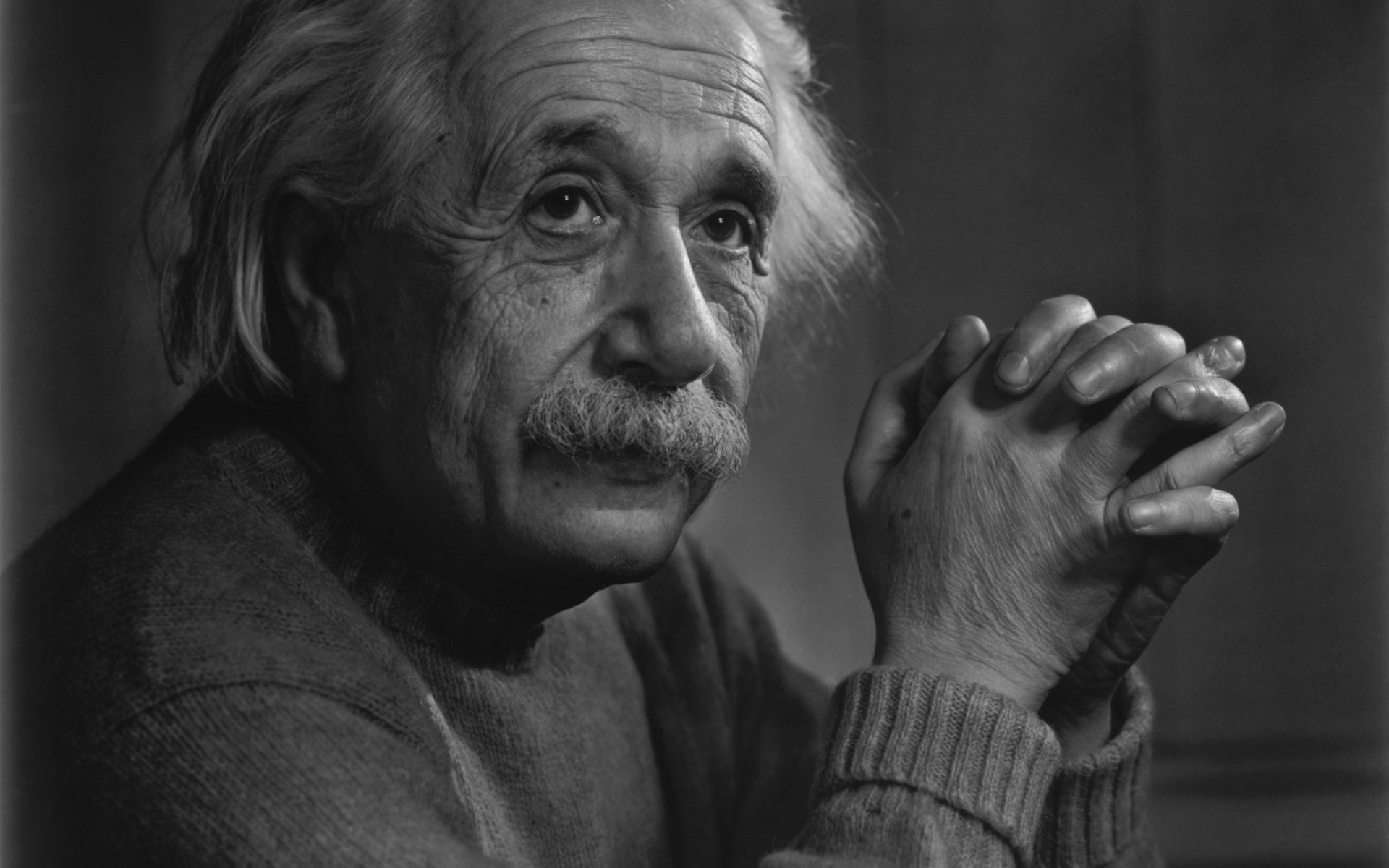 a man at the age scientist einstein genius portrait look mustache palm hands old age wrinkles eyes face