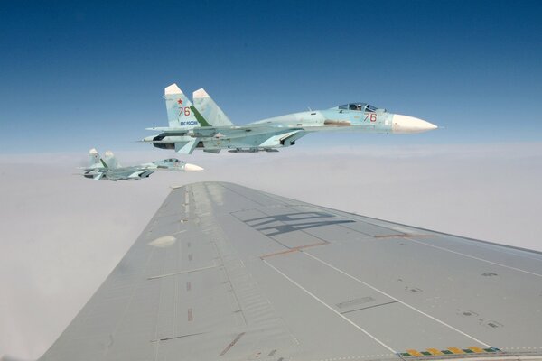 The wing of a military aircraft EA against the background of other aircraft