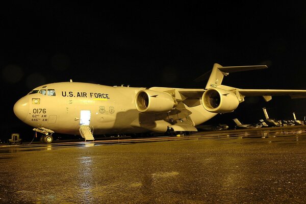 A big plane under a rain cover