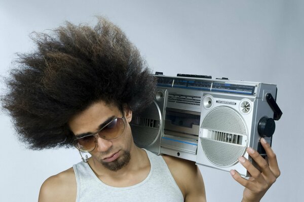 A guy with a lush hairstyle and a tape recorder