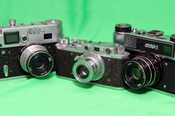 Retro cameras on a green background
