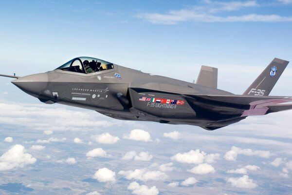 The F-35 military fighter soars above the clouds