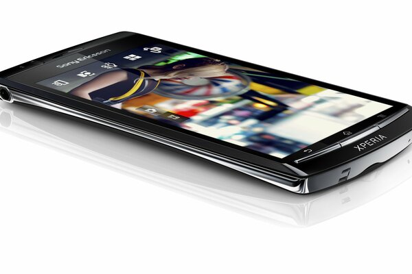 Hi-tech sony ericsson lies on a white background of the table and you can go online from your mobile to the Internet