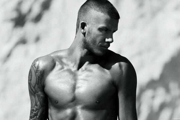 David Beckham bared his torso and his tattoos so that we could see his chest