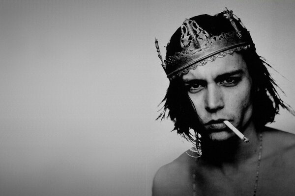 The legendary Johnny Depp with a crown and a cigarette in his teeth