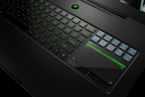 Black laptop keyboard with green backlight