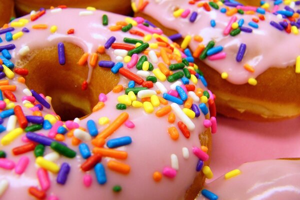 Donuts in pink glaze and with colored sprinkles