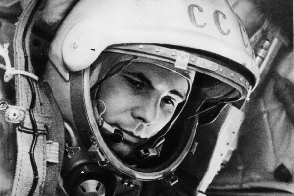 A black and white photo of Gagarin with a thoughtful expression on his face