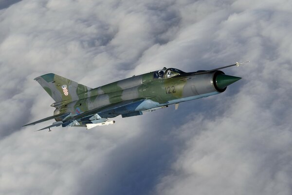 A Soviet plane is flying among the clouds at high speed