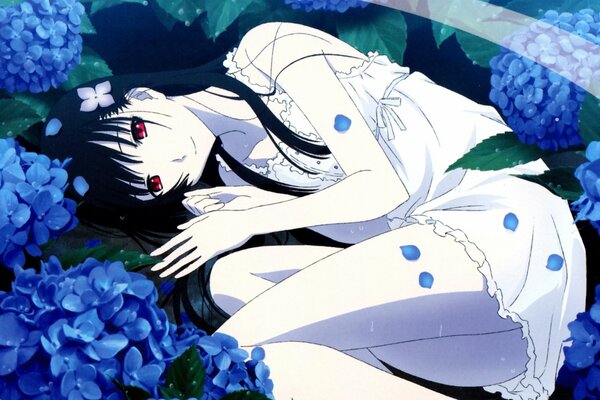 A girl with red eyes lying in blue flowers