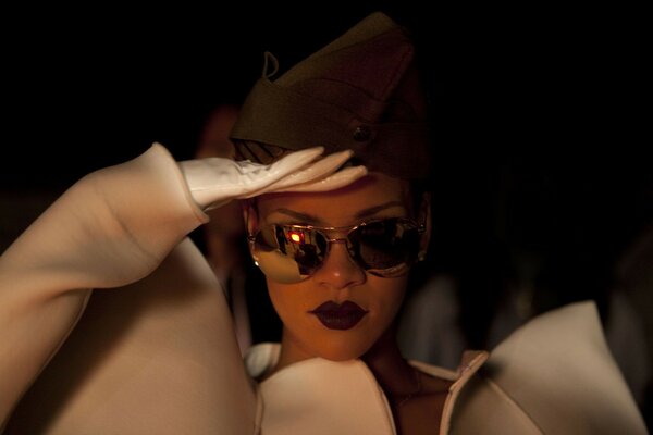 Rihanna in a cap and black glasses