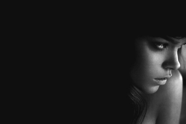 Profile of a beautiful girl on a black background