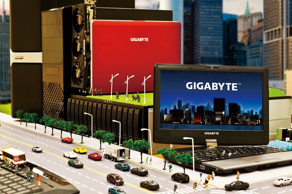 Pubblicità del laptop gigabyte in miniatura con macchine e persone