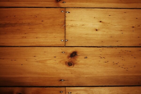 Nails in brown wooden boards