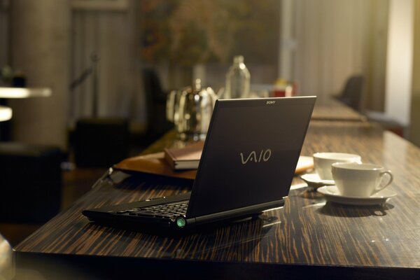Czarny laptop na ciemnym biurku