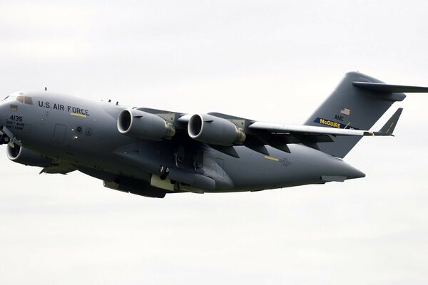 Grey military Boeing in flight