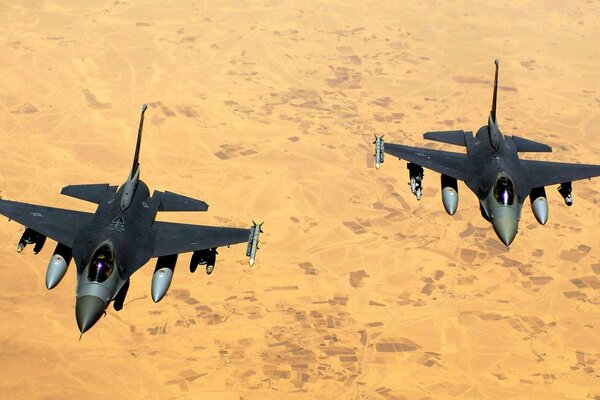 Military fighters in the sky over the desert