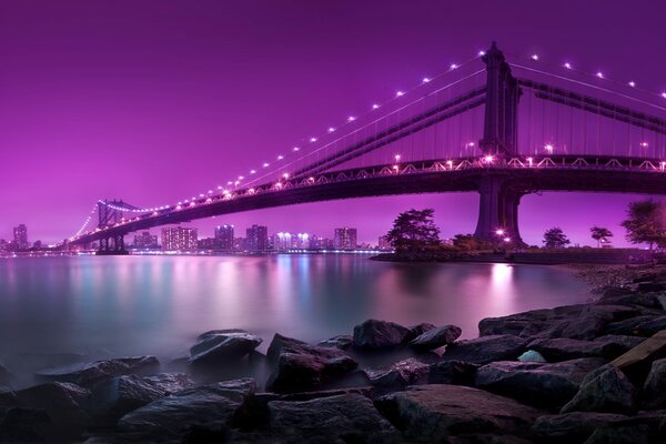 Manhattan Bridge of New York against the background of purple sky colors