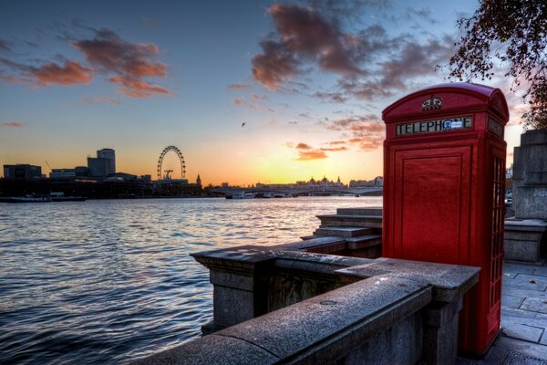 Red telephone booth on the embankment