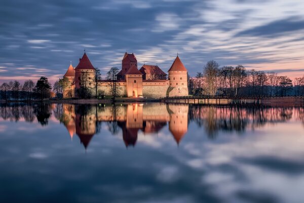 Castle on the shore of a foggy lake