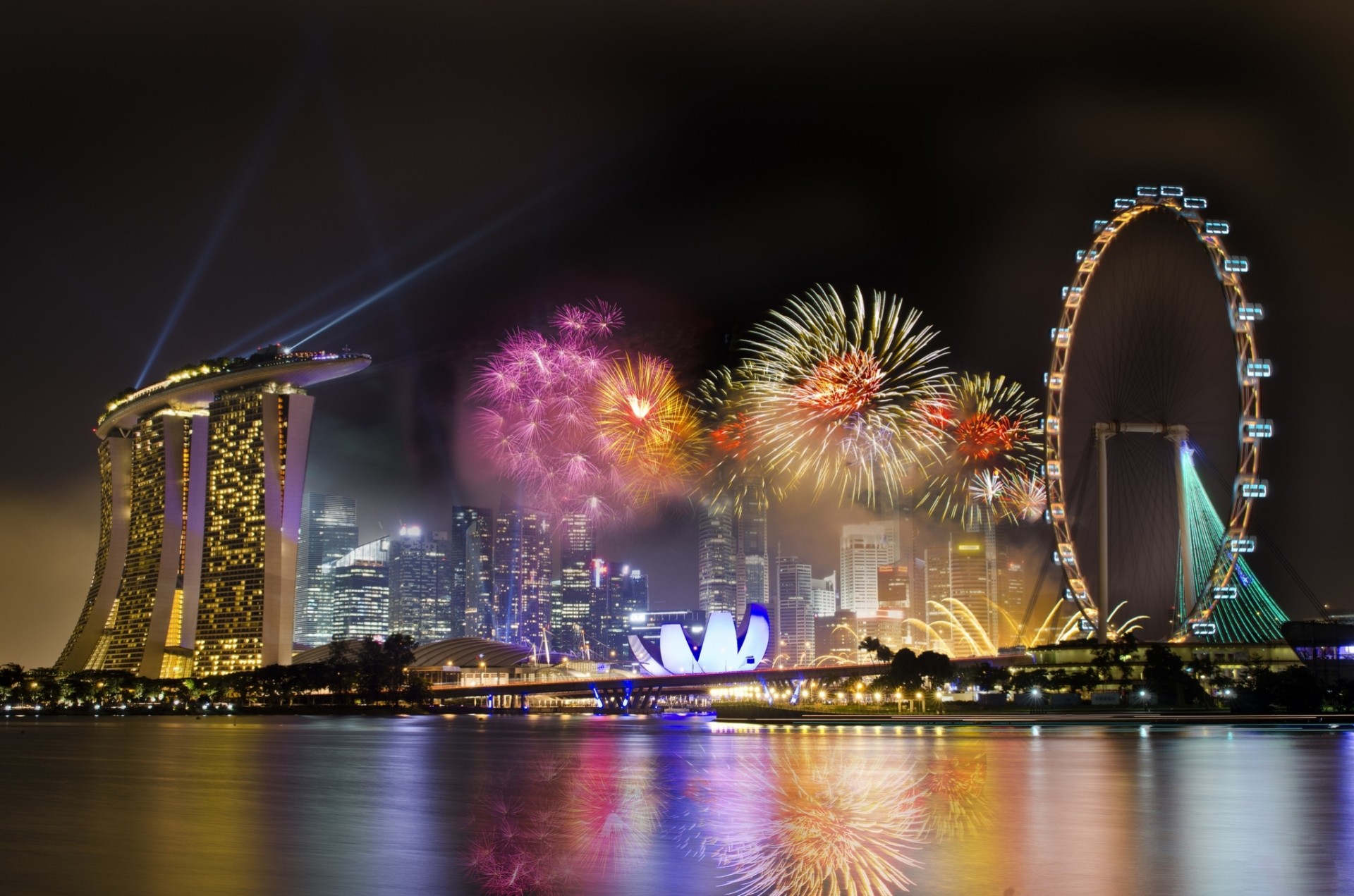 fireworks night fireworks holiday wheels city sky singapore ferris hotel