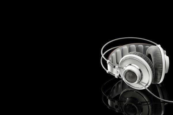 White headphones on a black background