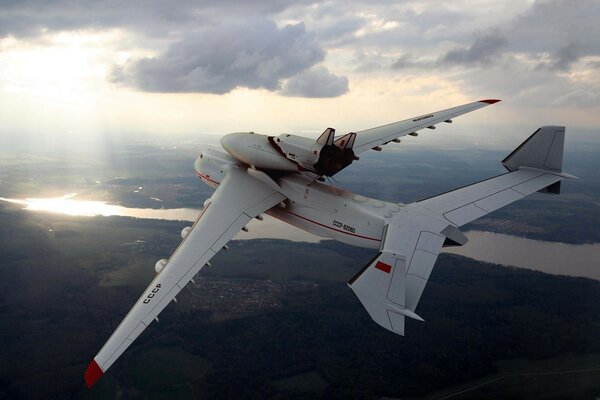 A white plane in a gray sky