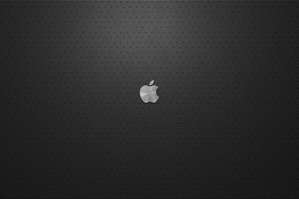 Эмблема надкушенное яблоко с серебристым отливом на чёрном фоне
