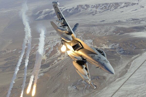 F - 18 fighter launches missiles