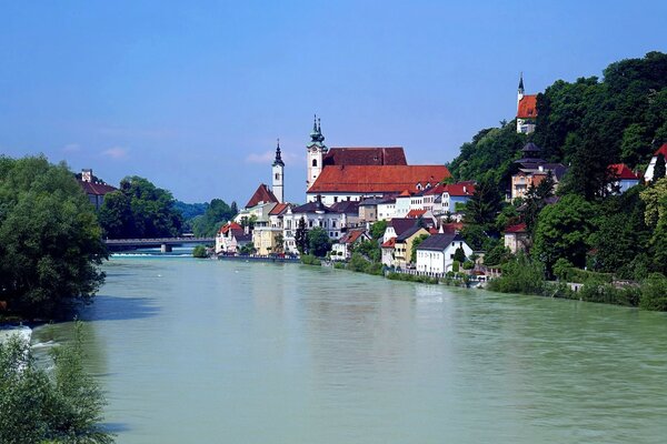 Houses near trees along the river