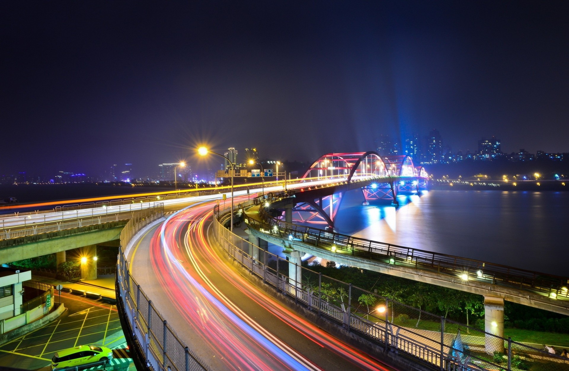 lights bridge night river town