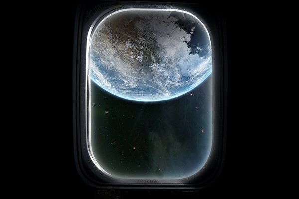 The earth in the porthole on a black background