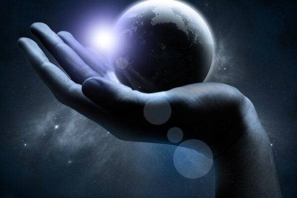 The hand holds the planet. Beautiful universe