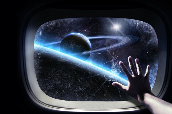 Hand on the porthole in space next to the planets