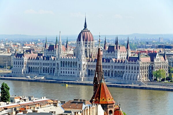 Hungary is a city by the water beautiful houses and clouds