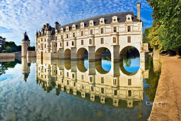 The castle is reflected in the water