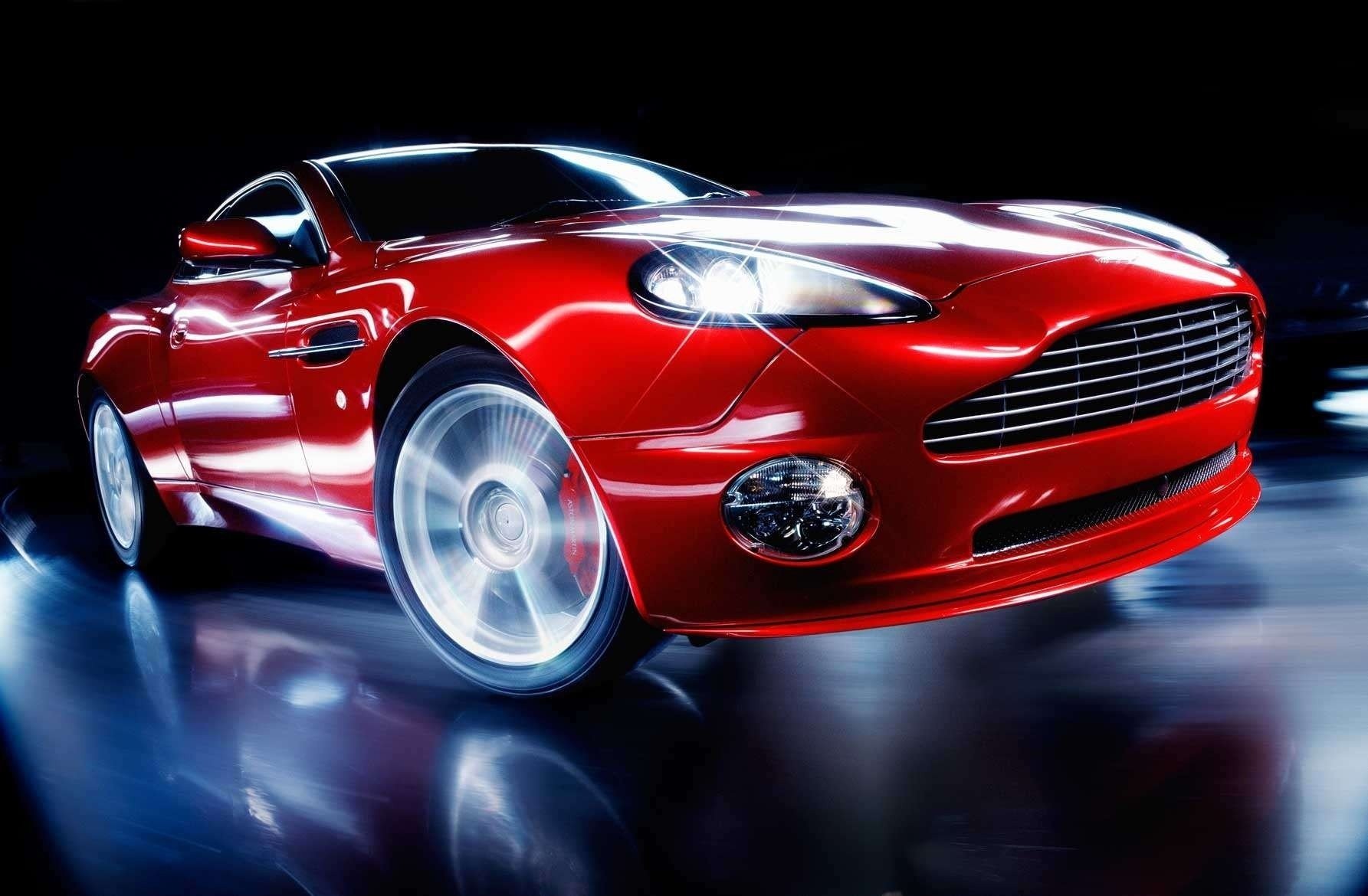 roter aston martin scheinwerferlichtglanz scheinwerferlicht kurve geschwindigkeit blur glanz luxus auto rotes auto cooles auto sportwagen transport kraftfahrzeuge form stil design ausstellung ausstrahlung aston martin