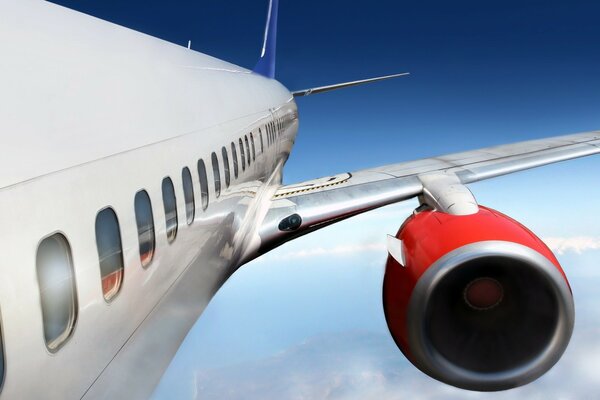 View of a turbine and an airplane wing in the sky